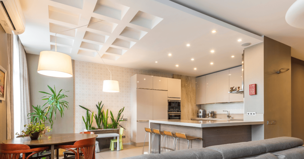 Image of a modern home interior with inset ceiling lighting spotlights and hanging fixtures